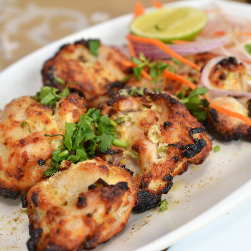 greek style boneless chicken on a white plate