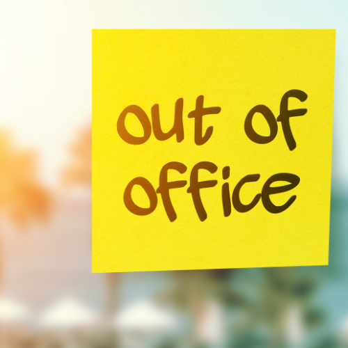 post it note with text out of office stuck on a window