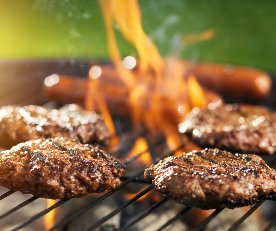 Rissoles cooking on a bbq with flames